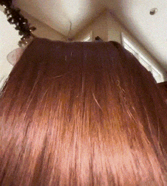 a close up of a woman 's hair in a room