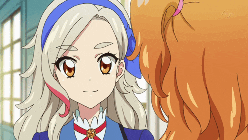 a girl with blonde hair and a blue headband looks at another girl with orange hair