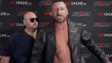 two men standing in front of a wall that says betonline