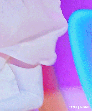 a drag queen wearing a white dress and pearl necklace
