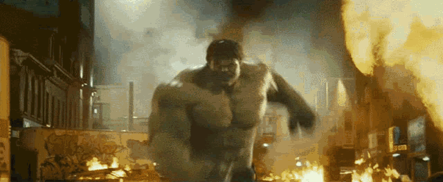 the hulk is running through a burning city with smoke coming out of his mouth .