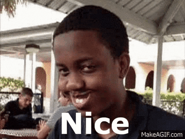 a young man is making a funny face with the word nice in front of him