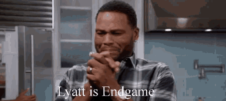 a man in a plaid shirt is crying in a kitchen with the words `` lyett is endgame '' above him .