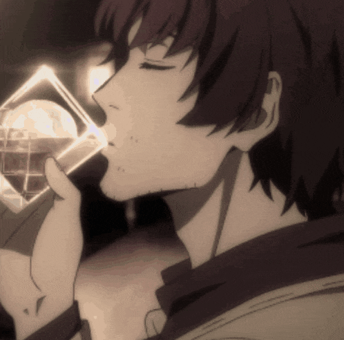 a close up of a person drinking from a glass with their eyes closed