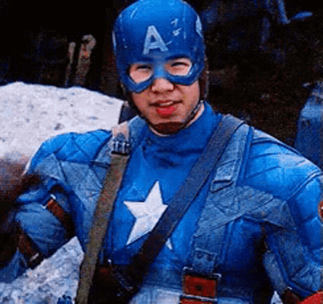 a man in a captain america costume is wearing a helmet with a letter a on it