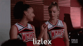 two cheerleaders from wmhs are sitting next to each other in a room .