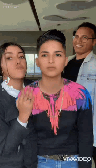 a man and two women are posing for a picture .