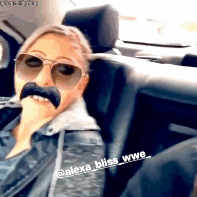 a woman wearing sunglasses and a fake mustache is sitting in the back of a car .