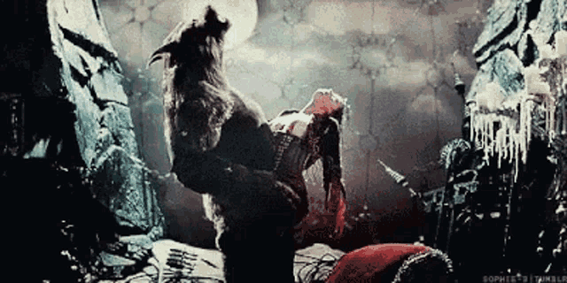 a woman is being attacked by a werewolf in a scene from a movie .
