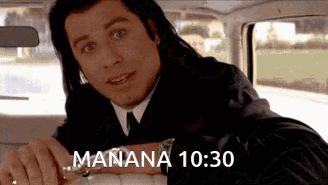 a man in a suit and tie is looking at his watch with the time 10:30 on the bottom