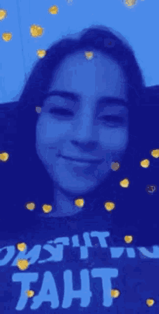 a close up of a woman 's face with hearts falling around her .