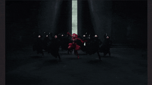 a woman in a red dress is surrounded by people