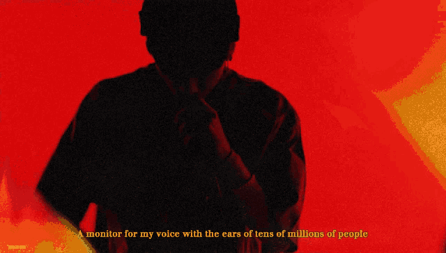 a man singing into a microphone with the words " a monitor for my voice with the ears of tens of millions of people "