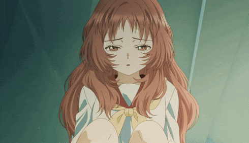 a girl with long red hair is sitting down and looking at the camera