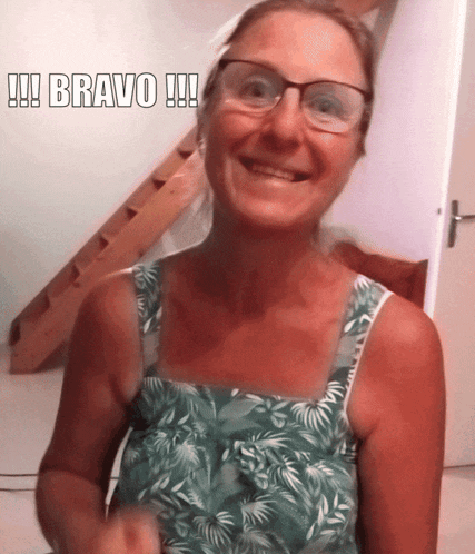 a woman wearing glasses is smiling with the caption bravo