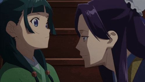 a girl with green hair and a purple haired girl looking at each other
