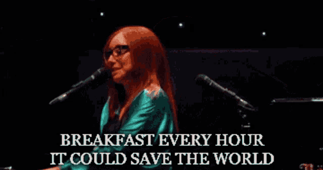 a woman singing into a microphone with the words breakfast every hour it could save the world on the bottom