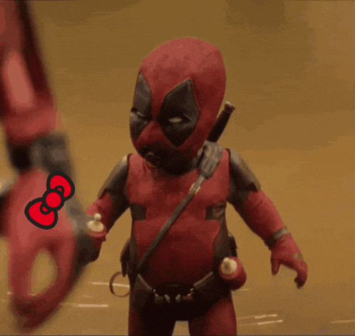 a deadpool doll is holding a hello kitty bow