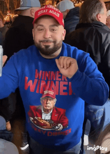 a man wearing a blue sweater that says winner winner