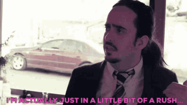 a man in a suit and tie is saying that he is actually just in a little bit of a rush .