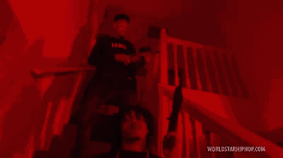 a man standing on a set of stairs with a worldstarhiphop.com logo