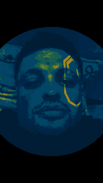 a man 's face is glowing in a blue light