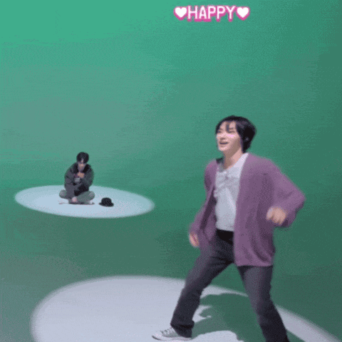 a man in a purple cardigan is dancing in front of a green screen with the words happy written above him