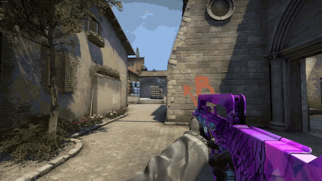 a person holding a purple gun in front of a brick wall