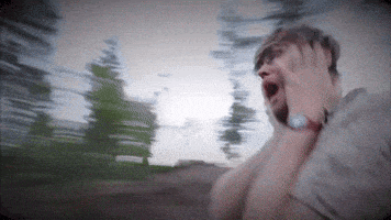 a blurry picture of a man screaming with his mouth open