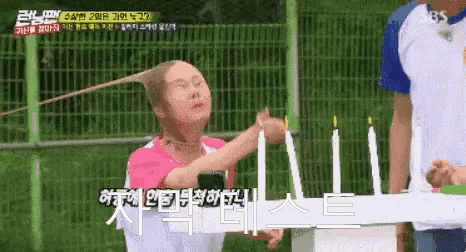 a woman is holding a bunch of candles in front of her face
