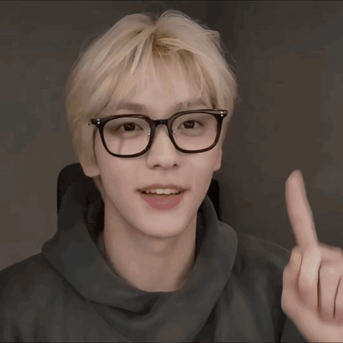 a yellow smiley face wearing glasses and giving a rock sign