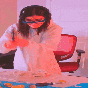 a woman wearing glasses and headphones is working on a piece of paper