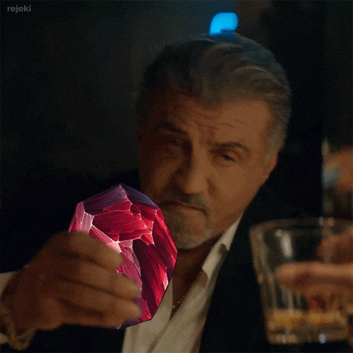 a man in a suit is holding a purple object in his hand and the word rejeki is on the bottom