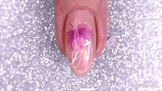 a close up of a nail with a flower design