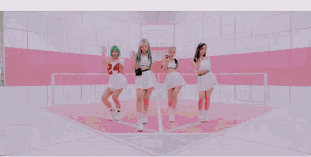 a group of young women are standing next to each other in a room .