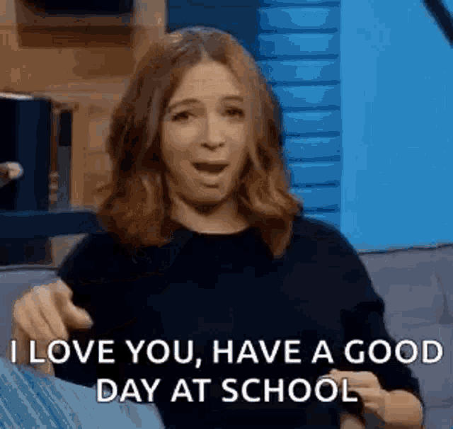 a woman is sitting on a couch saying `` i love you , have a good day at school ''