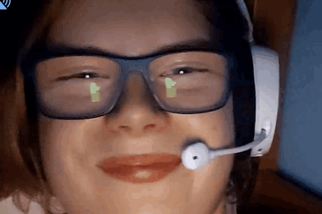 a woman wearing glasses and a headset with a microphone