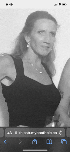 a black and white photo of a woman on a phone
