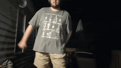 a man wearing a t-shirt with a picture of bottles and glasses