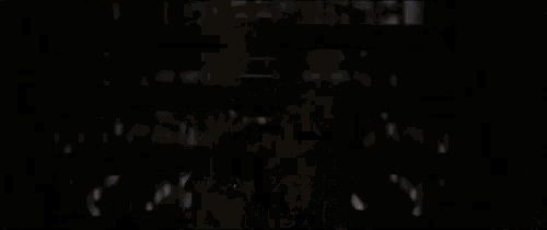 a silhouette of a person standing in front of a window in a dark room