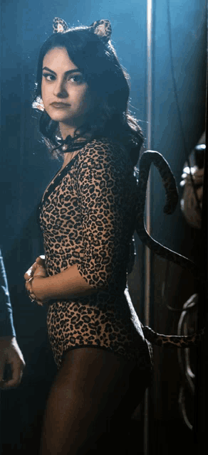 a woman wearing a leopard print bodysuit with cat ears