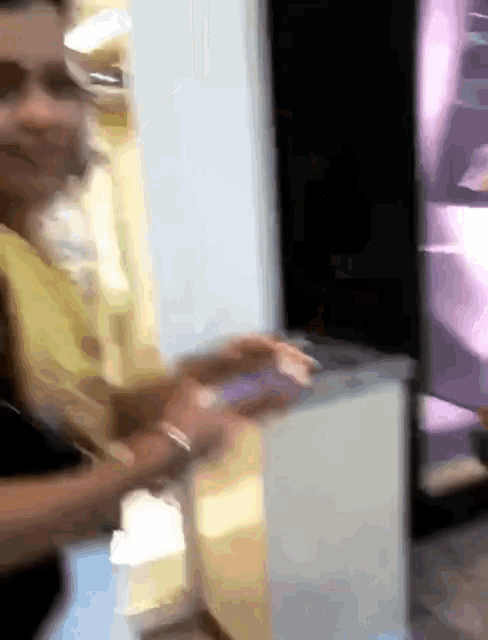 a blurry picture of a person standing in front of a purple wall