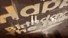 a close up of a sign that says `` happy birthday '' on it .