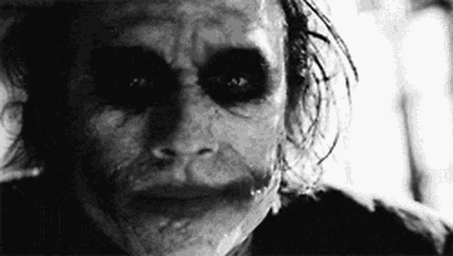 it is a black and white photo of the joker from the movie the dark knight .
