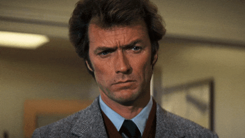 a close up of a man 's face with a serious look on his face