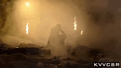 a silhouette of a man in a smokey area with the letters kvvcsr below him