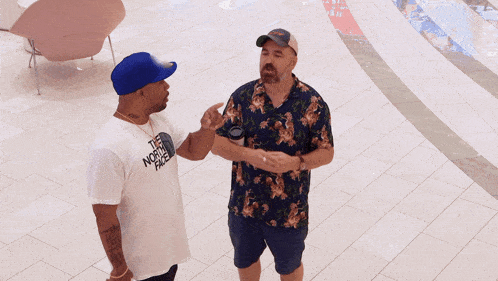 two men are standing next to each other and the word inter is on the tile floor