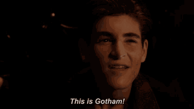 a young man is smiling and saying this is gotham
