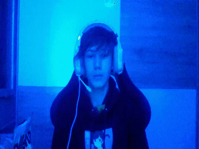 a person wearing headphones and a hoodie with a picture of a cat on the front