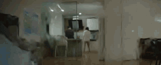 a blurry picture of a living room with a painting on the wall